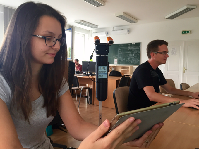 robot reads text on a tablet
