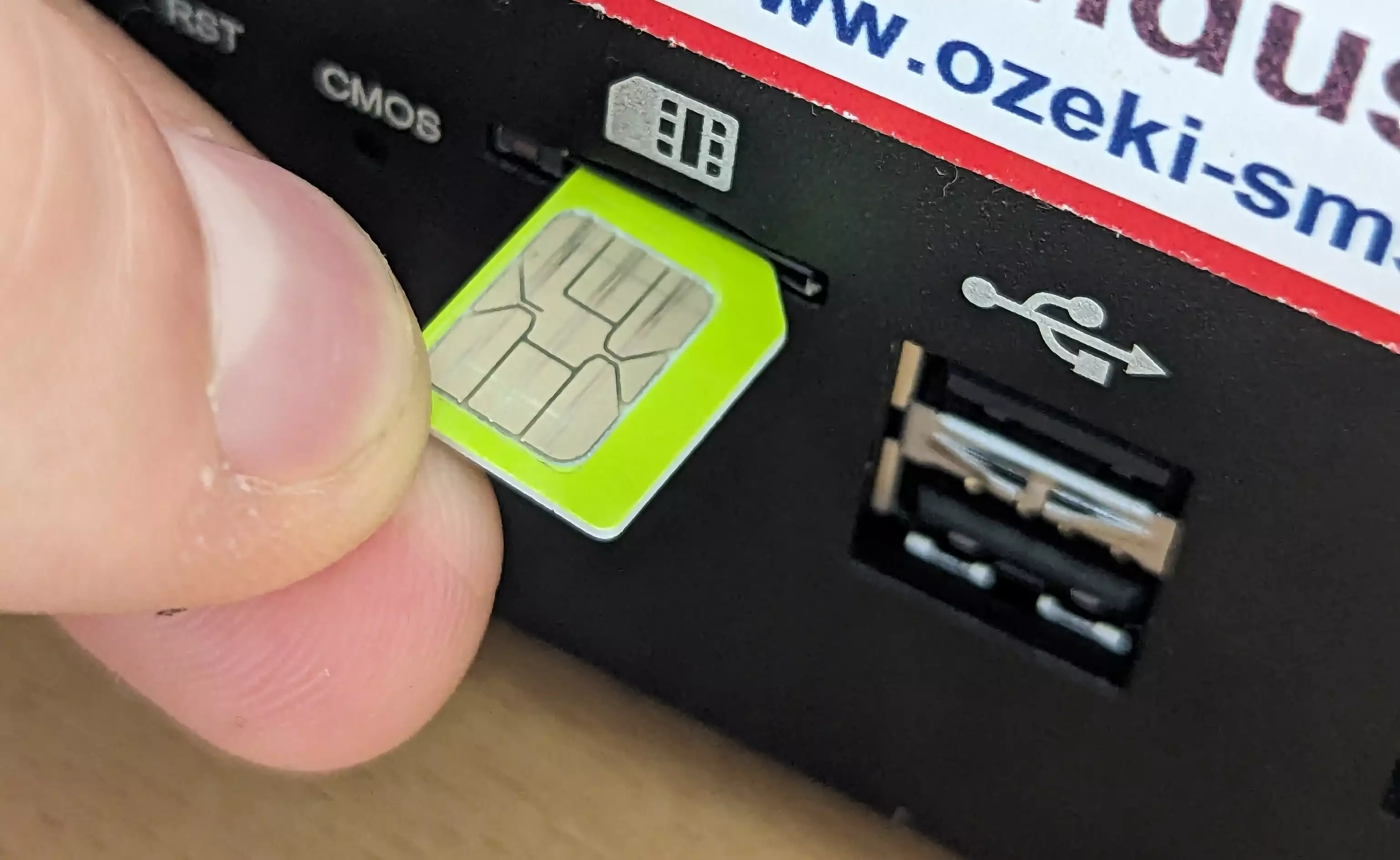 sim card being inserted with notch facing toward the slot and contacts facing drawing